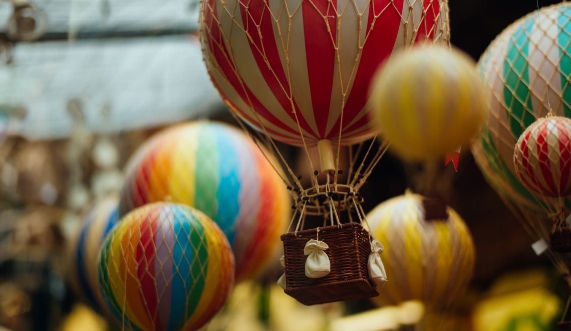 Selective focus shot of a lot of colorful air balloons with a blurred background